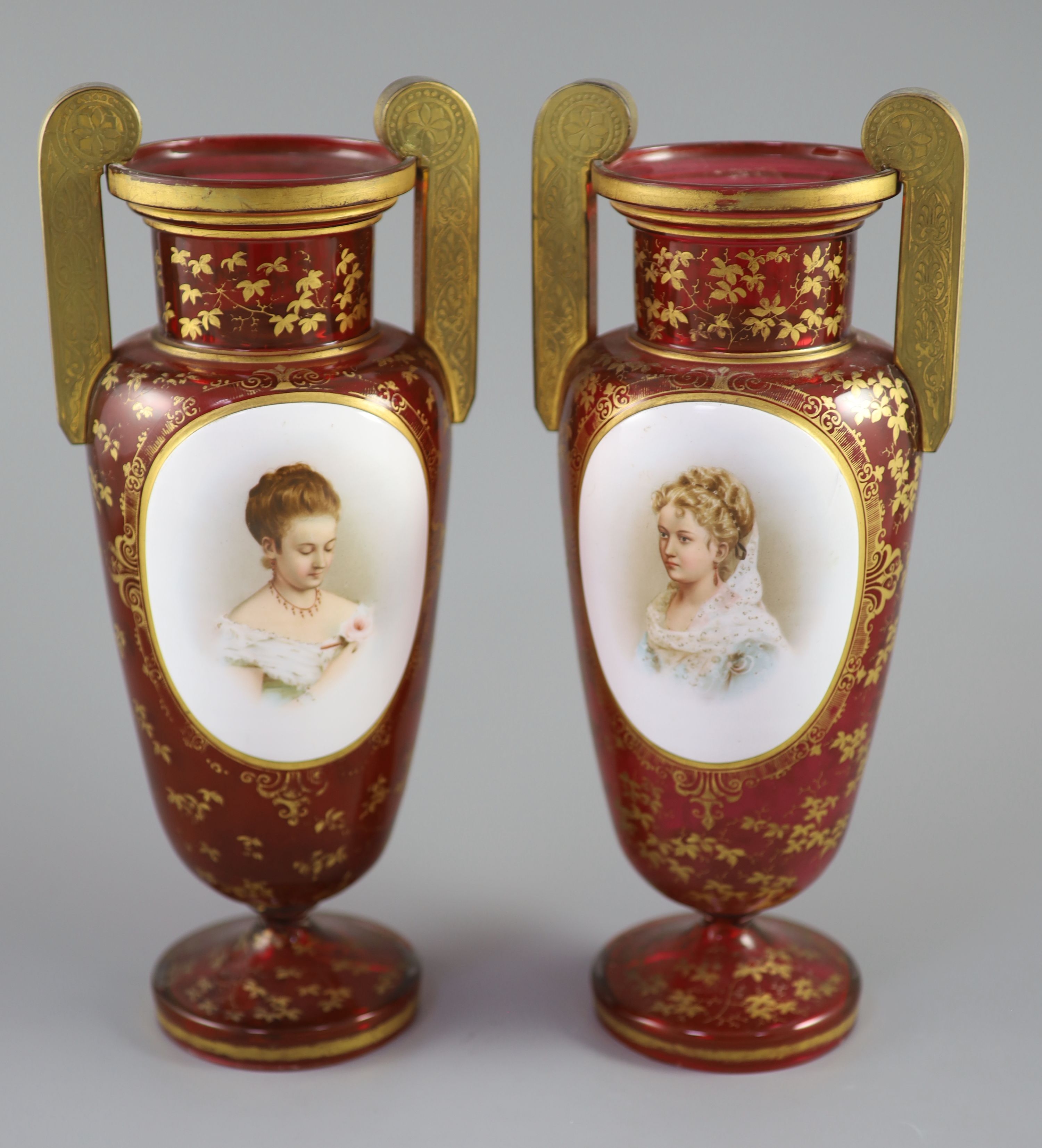 A pair of Bohemian gilt decorated ruby glass two handled vases, late 19th century, height 32cm